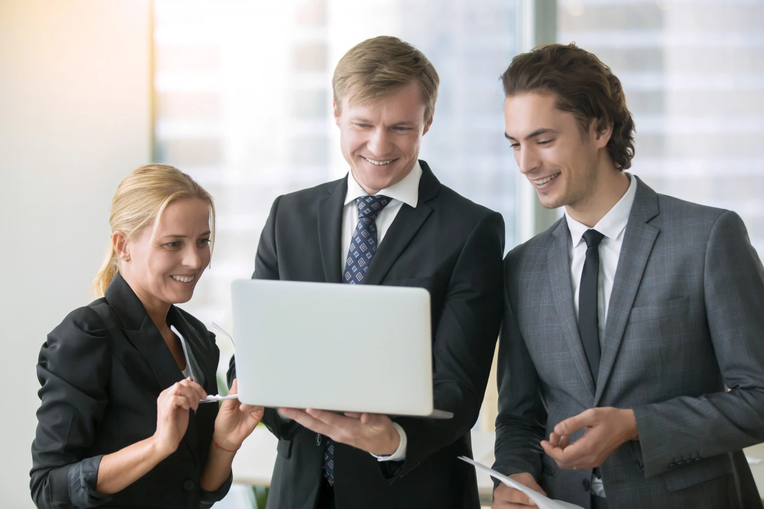 Business Valuation 5 Business team smiling at laptop
