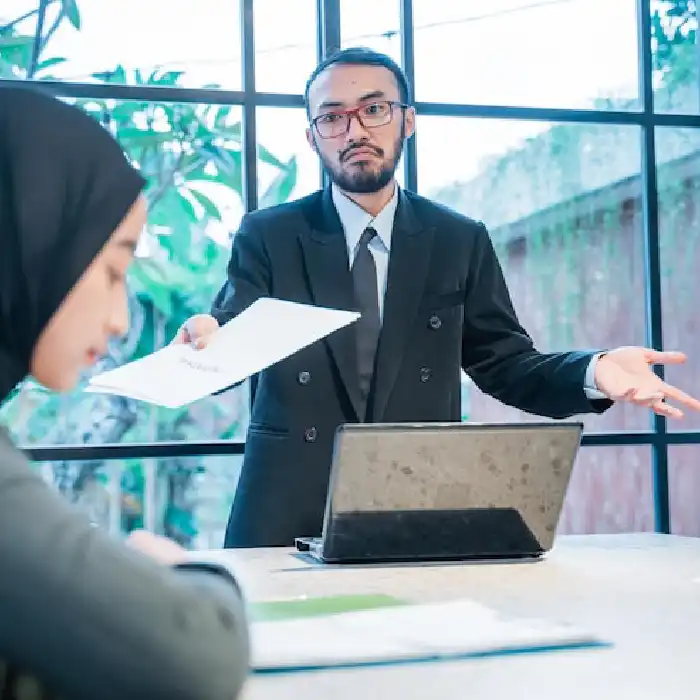 Auditor presenting documents during an attestation discussion.