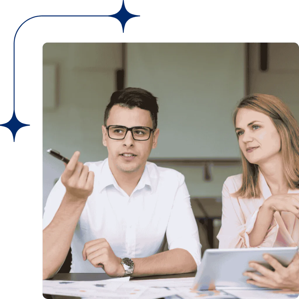 DMCC-Approved Auditors 4 Two certified auditors in a meeting room preparing an audit report for a DMCC company, reflecting expertise and regulatory compliance.
